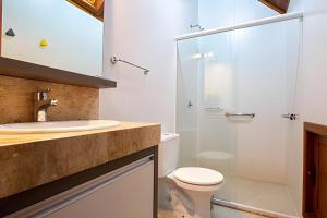 a bathroom with a toilet and a glass shower at Rosa Casa Morar da Serra in Canela +22 photos
