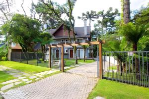 a gate in front of a house at Rosa Casa Morar da Serra in Canela