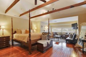 a bedroom with a bed and a living room at Canal Street Inn in New Orleans +63 photos