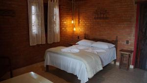 Ένα ή περισσότερα κρεβάτια σε δωμάτιο στο Chalés Ouro de Minas