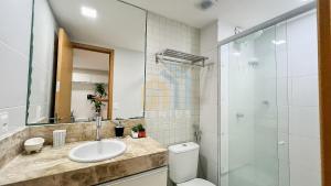 a bathroom with a toilet and a sink and a shower at Eco Summer Tambaú WB Genius Flats in João Pessoa