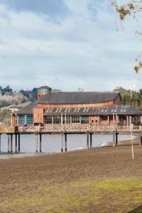 a pier with a building on top of the water at Depto nuevo 5 estrellas, ubicación insuperable in Puerto Varas