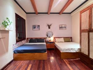 En eller flere senge i et værelse på NGÁO Home - Giảng Võ + 122 billeder