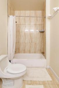 a bathroom with a toilet and a bath tub at Luxurious & Comfy Private Room in DC in Washington