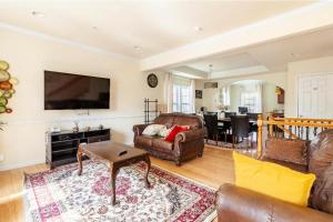 a living room with a couch and a table at Luxurious & Comfy Private Room in DC in Washington +2 photos