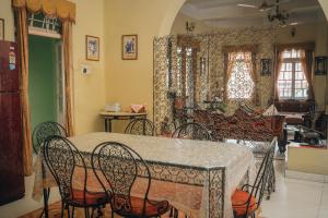 a dining room with a table and chairs at Baruah Bhavan Homestay in Guwahati