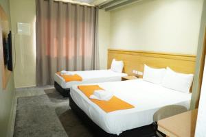 Postel nebo postele na pokoji v ubytování Hotel Golden Flora