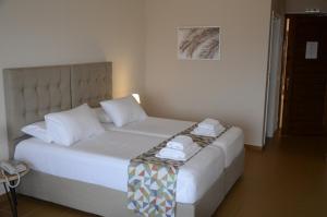 Ένα ή περισσότερα κρεβάτια σε δωμάτιο στο CHIOS HOTEL
