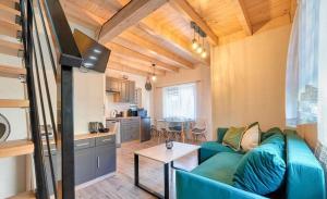 a living room with a couch and a table at Bliźniakówka in Brenna