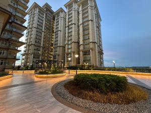 a large apartment building with two large tall buildings at Kuching Cozy Comfort 03 - Riverine Diamond Kuching 5 Pax in Kuching