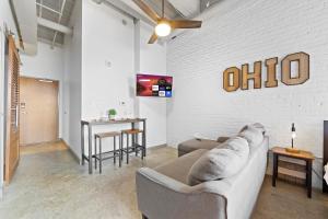 a living room with a couch and a table at 107-Cozy Loft Haven Parking Fast Wi-Fi Cafe in Cleveland