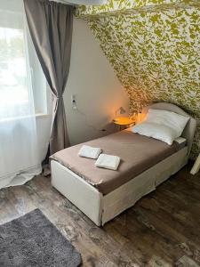 a bedroom with a bed with two towels on it at Apartment DAHL 3 Zimmer in Blankenfelde
