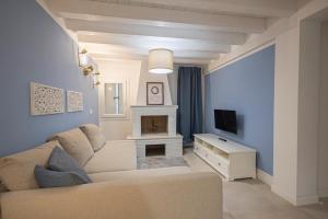 a living room with a couch and a fireplace at Sant'Andreas house 04 in Chioggia