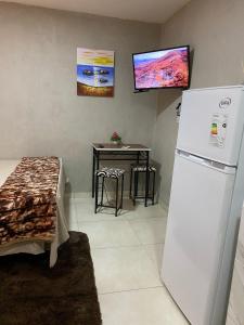 a kitchen with a white refrigerator and a table at LFA House 1 in San Lorenzo