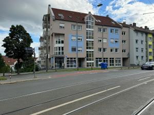 a large building on the side of a street at Candy Vibe Inn in Nuremberg