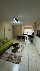 a living room with a green couch and a table at Bv San Juan - Nva Cba in Córdoba