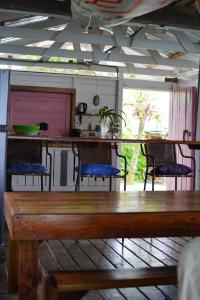 a dining room with a wooden table and chairs at Boathouse Bungalows By The Sea in Bocas Town