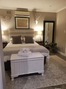 a bedroom with a bed with two towels on it at Gray Cottage in Strand