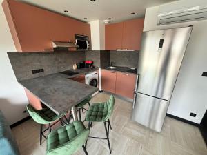 a kitchen with a table and chairs and a refrigerator at Cosy 2p in Cagnes-sur-Mer +7 photos