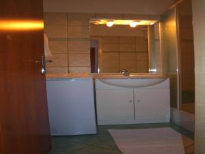 a bathroom with a sink and a mirror at Apartments Mia in Postira