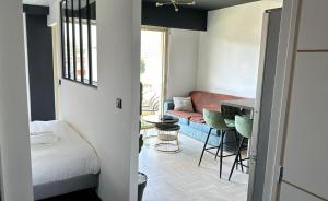 a room with a bed and a couch and a table at Cosy 2p in Cagnes-sur-Mer