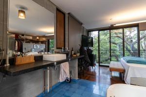 un bagno con un lavandino e un letto in una stanza di Blaze s SkateHouse Eco-spa e Refugio- Atibaia, SP ad Atibaia Altre 40 foto