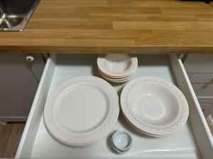 two plates and a spoon on a shelf in a cabinet at ALICE Daire in Konak +38 photos