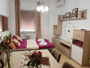a bedroom with a bed and a dining room table at casa Aldini in Rome