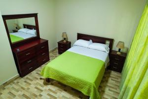 a bedroom with two beds and a large mirror at Logan's Paradise Vacation Home in Tena