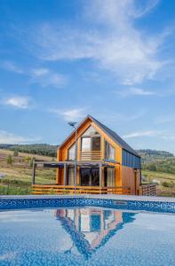 a house with a swimming pool in front of it at Podgórski Chill in Dziwiszów