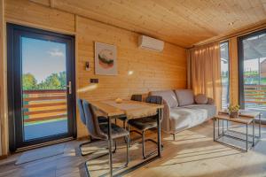 a living room with a table and a couch at Podgórski Chill in Dziwiszów