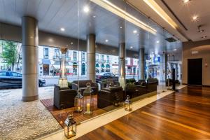 a lobby with couches and tables in a building at Czar Lisbon Hotel in Lisbon