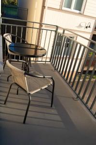 a table and a chair on a balcony at Suur-Posti Apartments in Pärnu