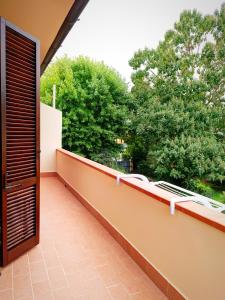 an outdoor balcony with a view of trees at Casa Grazia in Avane +4 photos