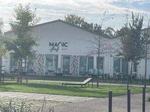 a white building with a bench in front of it at sublime appartement in Niort +1 photo