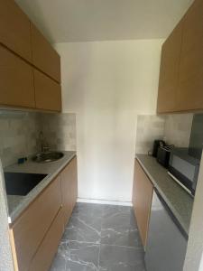 a small kitchen with a sink and a microwave at sublime appartement in Niort