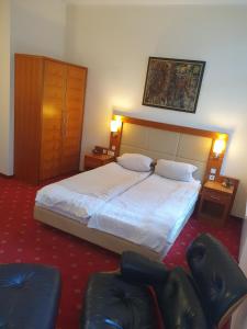 a hotel room with a bed and two chairs at die Villa, Zimmer 24, DZ in Leverkusen