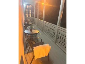 a balcony with a table and chairs on it at Crystal Hotel Tbilisi in Tbilisi City +48 photos