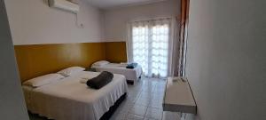 Ένα ή περισσότερα κρεβάτια σε δωμάτιο στο Casa Agradável no centro de Palmas TO