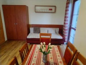 a room with a dining table and a bed at Chata Martin in Dolní Moravice +18 photos