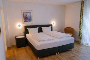 Ein Bett oder Betten in einem Zimmer der Unterkunft Hotel Klusenhof