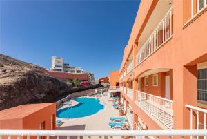 a view of a pool from the balcony of a hotel at Residence Playa Paraiso With Ocean View - Green Flat in Costa Calma