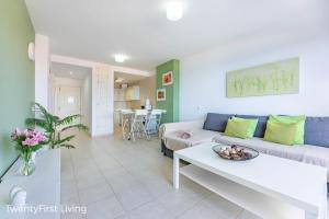 a living room with a couch and a table at Residence Playa Paraiso With Ocean View - Green Flat in Costa Calma