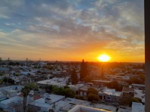 a view of a city at sunset at Departamento Buena Vista in Leones