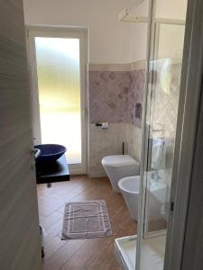 a bathroom with a shower and a toilet and a sink at Al Romito in Santo Padre +14 photos