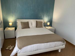 a bedroom with a large bed with two night stands at Al Romito in Santo Padre