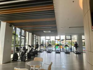 a gym with people exercising on treadmills in a building at K-Avenue by CC Suites 8-10pax ,2 free car park slot in Kota Kinabalu
