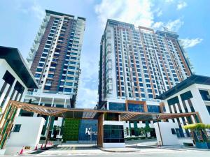 two large tall buildings in a city at K-Avenue by CC Suites 8-10pax ,2 free car park slot in Kota Kinabalu
