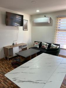 a living room with a couch and a table at Departamentos Aysen n1 in Puerto Aisén
