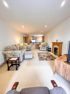 a living room with couches and a fireplace at 6 SERVICED APARTMENTS at ST JOSEPHS COURT, CLEETHORPES by VISIT CLEETHORPES in Cleethorpes